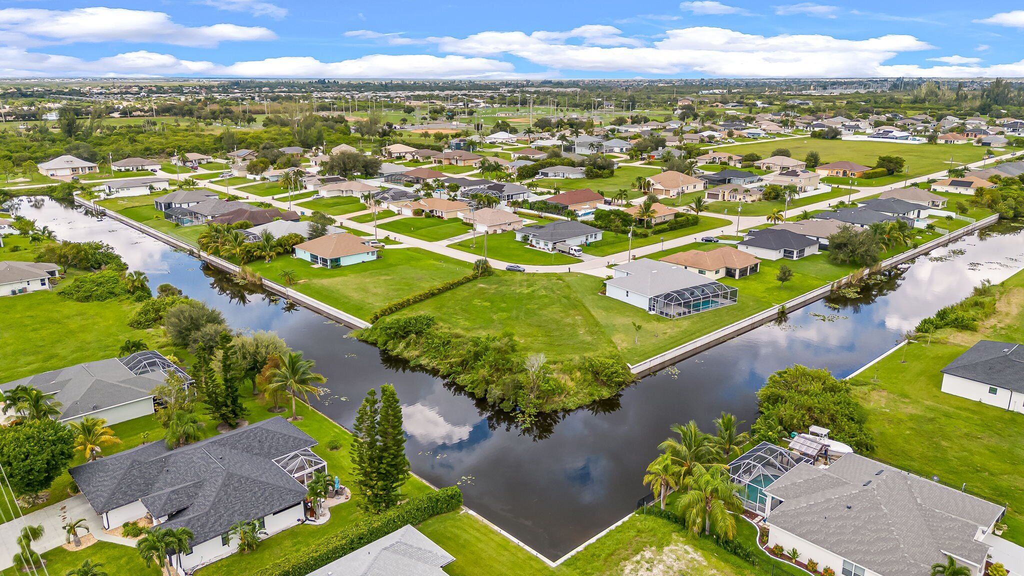 A residential area with houses, a canal, and a bridge.