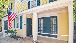 A two-story building with a yellow facade, white trim, and green shutters. - Near Downtown and Cornerstone - Southern Sunshine (Mobile)