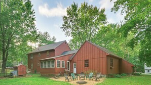 A red barn with a large open front porch and a small shed to the left. - 10 Mi to Crane Beach: Wooded Home Near Boston! (Topsfield)