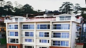 A multi-story building with a flat roof and multiple windows. - Aangan Premium Shimla (Shimla)