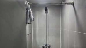 A modern shower stall with a handheld showerhead, a towel rack, and a toilet. - JINGOM STAY HOTEL (Seoul)