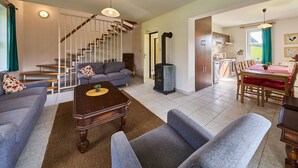 A modern living room with a staircase, a dining area, and a kitchen. - Green Valley Park Stárkov 1 by Interhome (Stárkov)