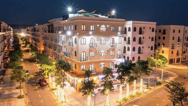 A multi-story hotel with a central courtyard, balconies, and a street view. - Anston Castle Hotel (Phu Quoc)