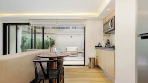 A modern kitchen with wooden cabinets and a stainless steel refrigerator. - w* | Prestigious Loft w/ Elegant Terrace in Colima (Ciudad de México)