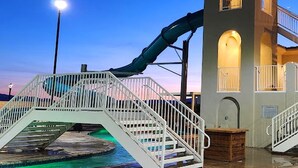 A water slide structure with a small tower and a staircase leading to a pool area. - Escape to your own private oasis in sunny Washington, Utah! (Washington)