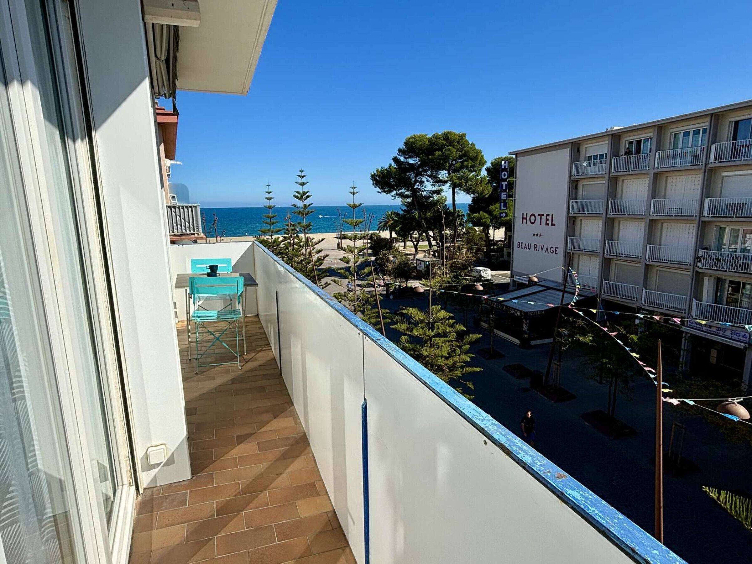 Un balcón de hotel con vistas a la playa y al océano.