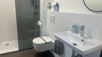 Shower, hair dryer, towels, shampoo