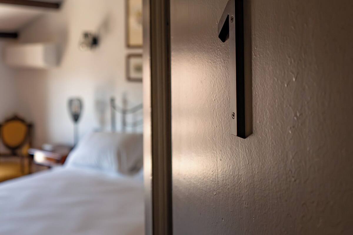 A close-up of a door with a number 1 sign, indicating a room number.