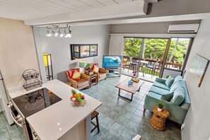 A modern living room with a kitchen area, a sofa set, and a dining area. - Maui Vista 1403 | 2BR Kihei Condo Near the Beach (Kihei)