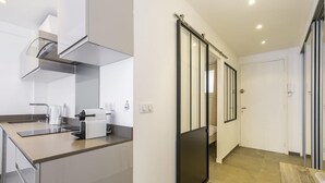 A modern kitchen with a built-in oven, a coffee machine, and a sink. - CIOLLI (Cannes)
