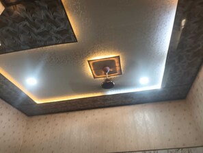 A ceiling with recessed lighting and a central control panel. - G.D Guest House By GRB (Mathura)