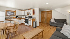 A compact living space with a kitchen, dining area, and a sofa.