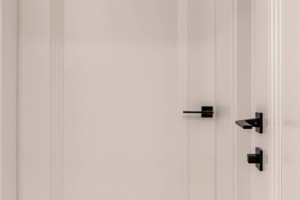A white door with two black handles.