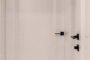 A white door with two black handles.