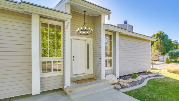 A two-story house with a front porch, a front door, and a visible chimney. - Smithfield Retreat: Ideal for Family Gatherings! (Smithfield)