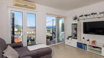 Apartment (One Bedroom Apartment with Balcony an) | Living room | 32-inch flat-screen TV with cable channels