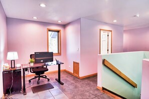 A room with a desk, computer, chair, lamp, and a window. - Fenced Acre for Dogs | Hot Tub | 4BR Sleeps 8 (Leadville)