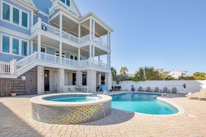 A multi-story building with a swimming pool, outdoor seating, and a covered patio area. - Anchor of the Soul: Oceanfront Luxury w/private pool & Amenities (Murrells Inlet)