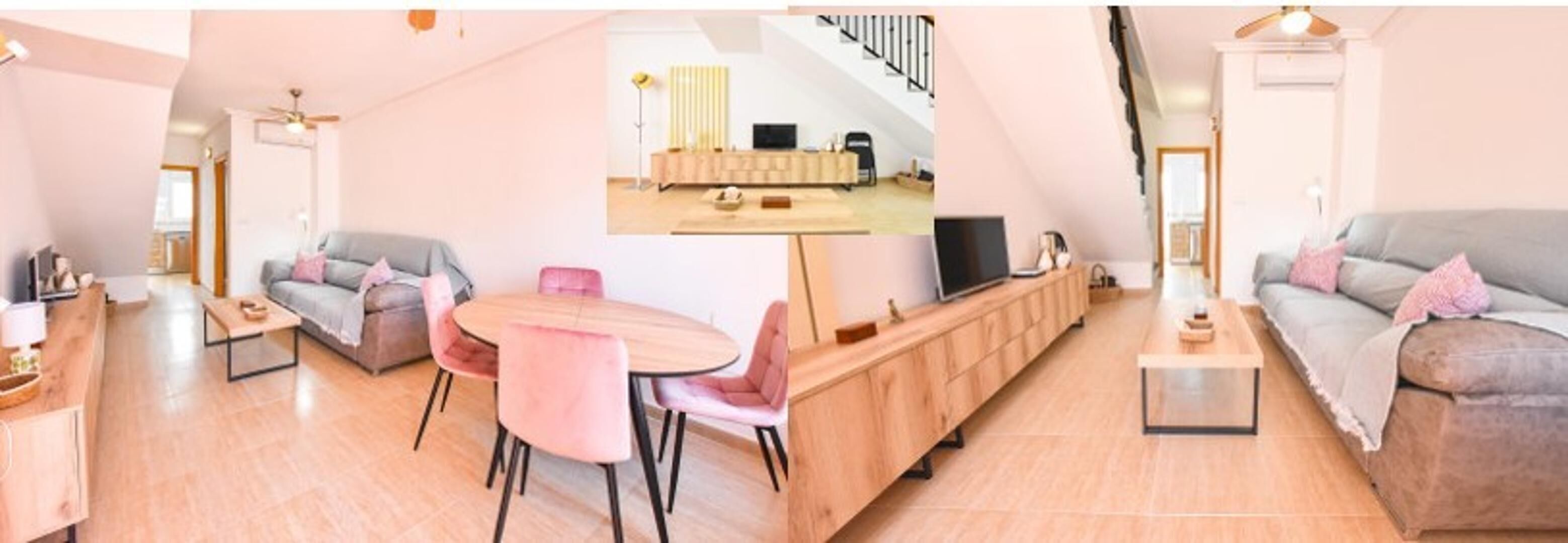 Una sala de estar moderna con un sofá gris, una mesa de centro de madera y un comedor con sillas rosas y una mesa de madera.