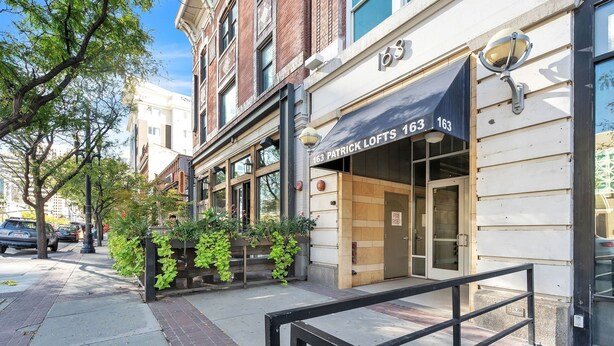A building with a sign reading "163 PATRICK LOFTS 163" and a fire exit sign. - Modern Condo With Mountain Views, Walk To Downtown 2 Bedroom Condo (Salt Lake City)