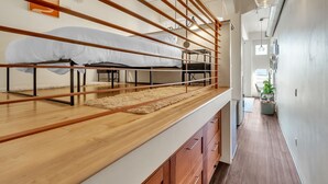 A modern loft bedroom with a bunk bed, wooden slats, and a large window. - Modern Condo With Mountain Views, Walk To Downtown 2 Bedroom Condo (Salt Lake City)