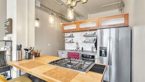 A modern kitchen with a central island, stainless steel appliances, and pendant lighting. - Modern Condo With Mountain Views, Walk To Downtown 2 Bedroom Condo (Salt Lake City)