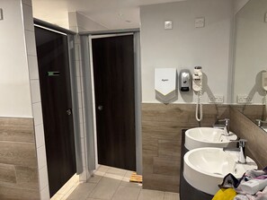 A modern bathroom with two sinks, a Dyson hair dryer, and a phone on the wall. - Riverside Boat Retreat on the River Thames (Windsor)