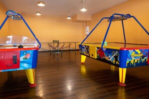 Two arcade machines in a room with wooden flooring and yellow walls. - Appartement im Panoramic Hotel Bad Lauterberg (Bad Lauterberg)