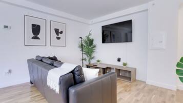 Economy Apartment | Living area | 50-inch Smart TV with cable channels