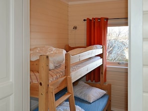 A bunk bed room with a window and a curtain. - 5 Person Holiday Home in Laukvik-by Traum (Vagan)