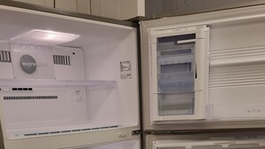 A double-door refrigerator with multiple shelves and a freezer compartment.