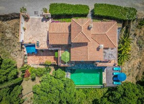 An aerial view of a property with a swimming pool, patio area, and a tiled roof. - Luxury Villa - Sleeps up to 8 & Infinity Pool (Estepona)