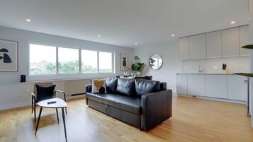 Comfort Apartment | Living area | 50-inch Smart TV with cable channels