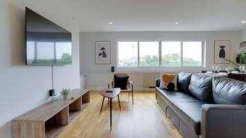 Comfort Apartment | Living area | 50-inch Smart TV with cable channels