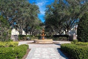 Stroll through a serene garden oasis with a central fountain and walking path.
