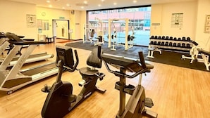 A gym with treadmills, elliptical machines, and free weights. - KL Grand Service Suite at Times Square (Kuala Lumpur)