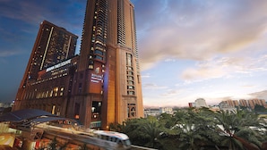 A high-rise hotel with multiple floors, prominent signage, and a modern architectural design. - KL Grand Service Suite at Times Square (Kuala Lumpur)