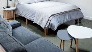 A modern bedroom with a bed, a sofa, a small table, and a TV. - Hilldale Studio - in the heart of Marin County (San Anselmo)