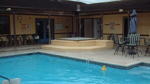 A swimming pool with a diving board and chairs around it. - The Acorn Ridge, with Pool Access! (Harlingen)