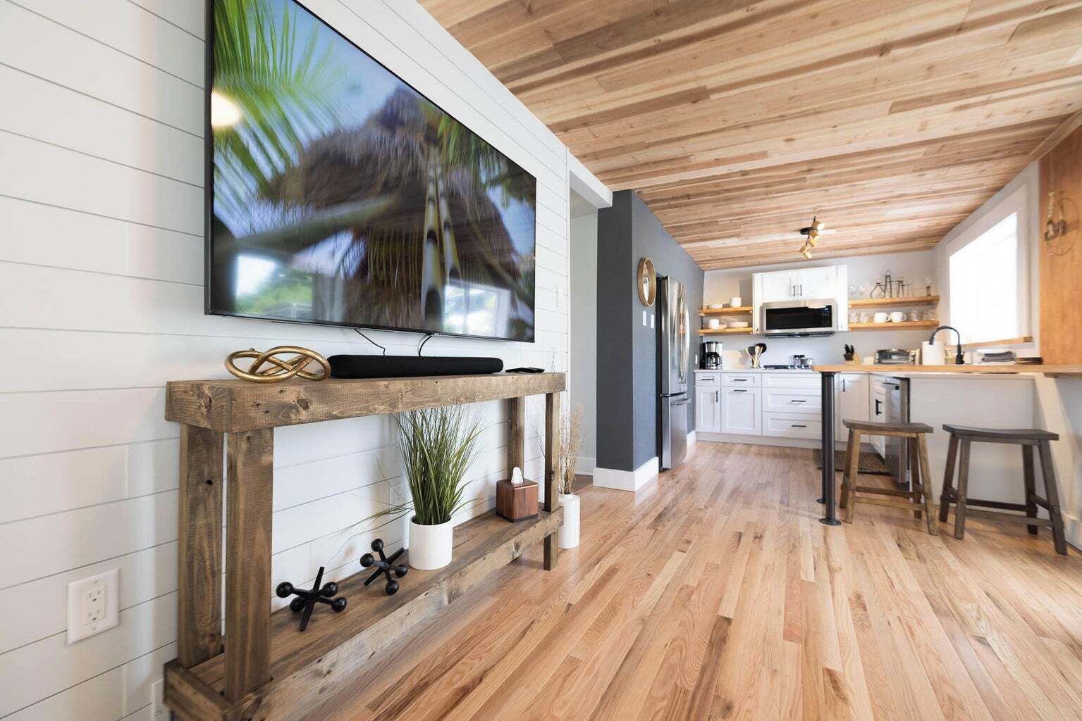 Second living space off the kitchen and back patio. Features a 70 in HD TV
