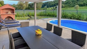A covered patio with a pool, outdoor furniture, and a brick barbecue area. - Awesome home in Krapinske Toplice (Krapinske Toplice)
