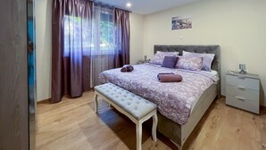 A bedroom with a bed, bench, nightstand, and a window with curtains. - Awesome home in Krapinske Toplice (Krapinske Toplice)
