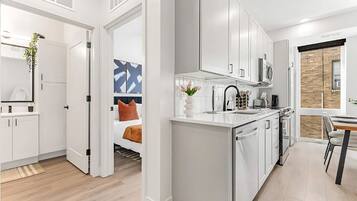 1 bedroom, desk, iron/ironing board, travel crib