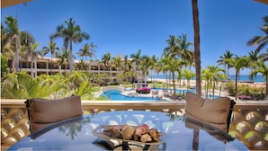 A resort with a pool, palm trees, and a view of the ocean. - Las Mañanitas LM C209 (Los Cabos)