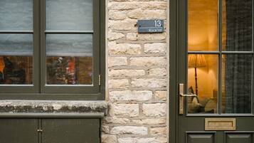 A building with a stone wall and a door labeled "13 Rock Hill."