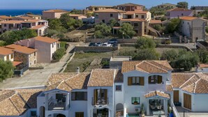 A coastal residential area with terracotta-tiled houses, a swimming pool, and a clear view of the sea. - Victoria by Interhome (Budoni)