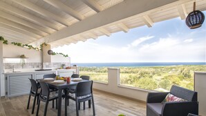 A spacious patio with a dining area, kitchen, and seating. - Stogu di Lusso by Interhome (Valledoria)