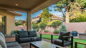 An outdoor patio area with a sofa set, two tables, and chairs. - Luxe 4-BR Home: Spa, Red Rock Views, and A+ Trails (Sedona)