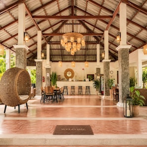 A spacious lobby with a high ceiling, a central reception desk, and a 'WELCOME' mat. - Khanom Seabeach (Khanom)
