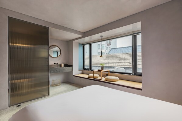 A modern bedroom with a large window, a bed, a bedside table, and a mirror. - (Beijing)